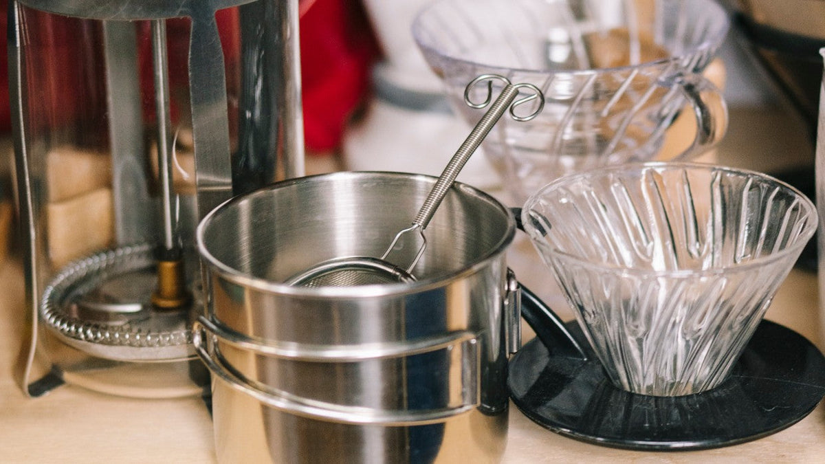 Pour-over drippers, a French press and a steel cup on the brew shelf in the Balzac Brothers lab